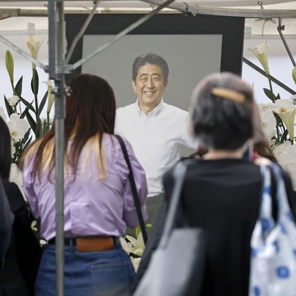 People offer flowers at an altar set up at Tokyo’s Zojoji temple, ahead of the funeral of former Japanese Prime Minister Shinzo Abe. Photo: Kyodo