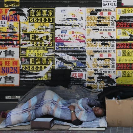 A homeless person sleeps in front of closed retail shops in Mong Kok on April 15. Hong Kong’s wealth inequality is growing worse as the pandemic drives people who were already struggling closer to the edge. Photo: Edmond So