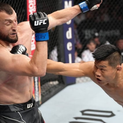 Li Jingliang of China punches Muslim Salikhov of Russia in a welterweight fight at UFC Long Island. Photo: Zuffa LLC