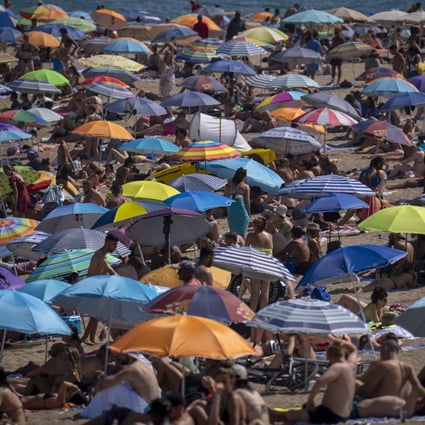 A packed beach in Barcelona, Spain, as temperatures reach record levels across Europe. Photo: AP