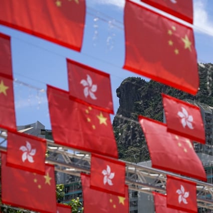 Chinese and Hong Kong flags against the backdrop of Lion Rock on June 26, ahead of the 25th anniversary of Hong Kong’s return to Chinese rule. National education has long been a missing piece of Hong Kong’s education puzzle, and a patriotic education centre can fill this gap. Photo: Felix Wong 