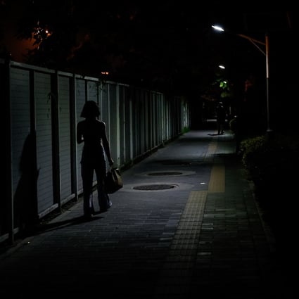 A woman walks along an alley in Beijing on July 8. A video of men attacking four women at a restaurant in Tangshan, Hebei province, in June has caused public outrage and raised awareness of the need for women’s safety. Photo: EPA-EFE