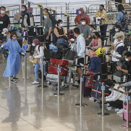 Travellers arrive at Hong Kong International Airport on July 8. On-arrival quarantine procedures at the airport involve queuing and waiting in packed areas. Photo: K.Y. Cheng 