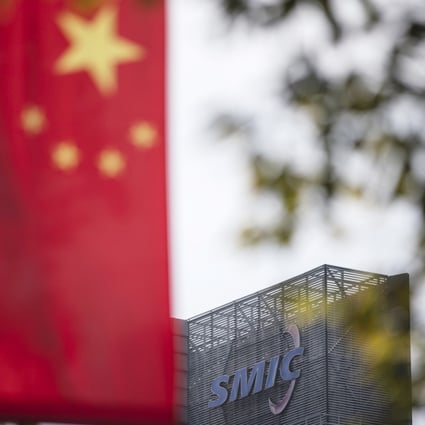 A Chinese flag near a logo atop the Semiconductor Manufacturing International Corp (SMIC) headquarters in Shanghai. Photo: Bloomberg