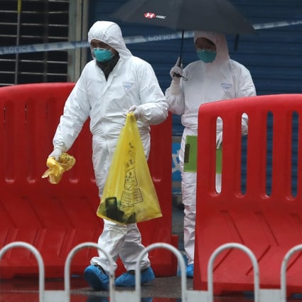 Quarantine personnel in full protective gear collect samples at  the Huanan Seafood Market  in Wuhan in January 2020. Photo: Simon Song