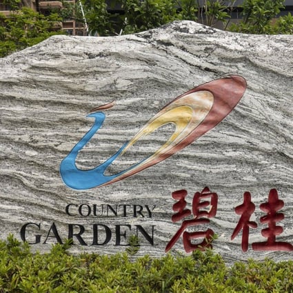 The logo for Country Garden Holdings is displayed at the company’s Fengming Haishang residential development in Shanghai, China. The company is raising US$330 million from a share sale in Hong Kong. Photo: Bloomberg