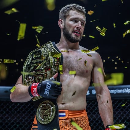 Reinier de Ridder celebrates with his ONE middleweight MMA title after submitting Vitaly Bigdash at ONE 159 in Singapore. Photo: ONE Championship.