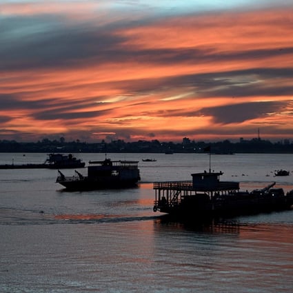 Ferries transport passengers and vehicles across the Mekong River in Phnom Penh. Cambodia’s policymakers are caught between the competing objectives of maintaining export development, stabilising the currency and safeguarding the livelihoods of low-income earners. Photo: AFP