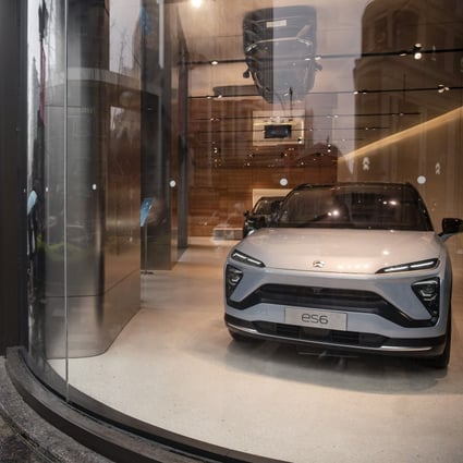Pedestrians walk past a Nio dealership in Shanghai, China. Photo: Bloomberg
