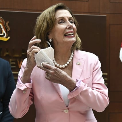 US House Speaker Nancy Pelosi removes her face mask as she meets Malaysia’s Parliament Speaker Azhar Azizan Harun in Kuala Lumpur on Tuesday. Photo: Handout via AP