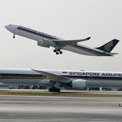 A Singapore Airlines aircraft takes off behind another of the carrier’s planes at Singapore’s Changi Airport. Photo: Reuters
