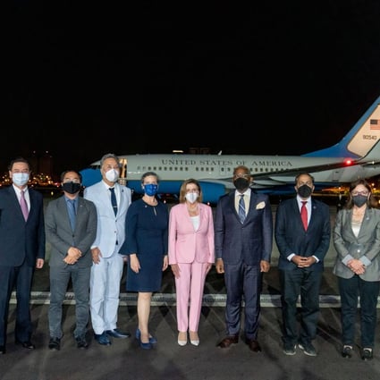 Nancy Pelosi (in pink) and her delegation pose for a picture upon their arrival at Taipei Songshan Airport. Photo: AFP