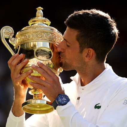 Novak Djokovic celebrates with the Wimbledon trophy after defeating Australia’s Nick Kyrgios in their men’s singles final match at the All England Lawn Tennis and Croquet Club in London on July 10. Photo: PA Wire/dpa