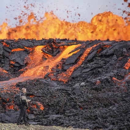 People look at the lava flowing on Fagradalsfjall volcano in Iceland on Wednesday. Photo: AP