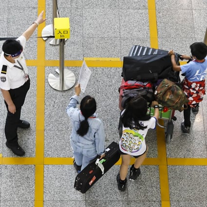 Passengers arrive at Hong Kong’s airport before being taken to quarantine hotels. Photo: K. Y. Cheng