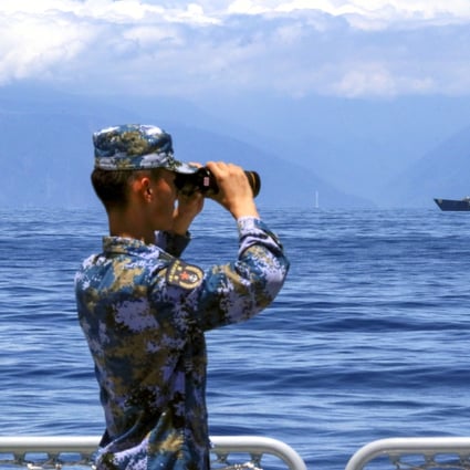 A soldier looks through binoculars during PLA Navy combat exercises and training in the waters around Taiwan on Friday. Photo: Xinhua