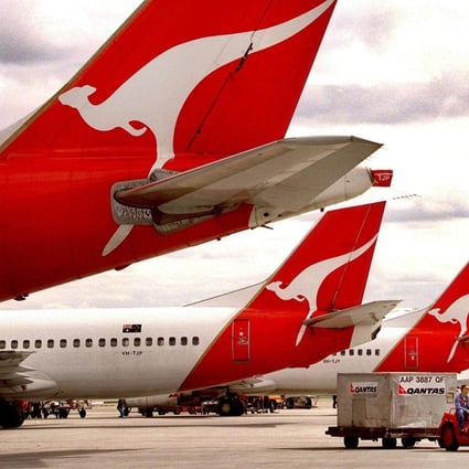 Baggage handlers drive a ground support vehicle around Qantas aircraft in Sydney. Driving the vehicles that take bags to planes and between terminals is one of the tasks the airline’s executives are being asked to cover. Photo: AFP