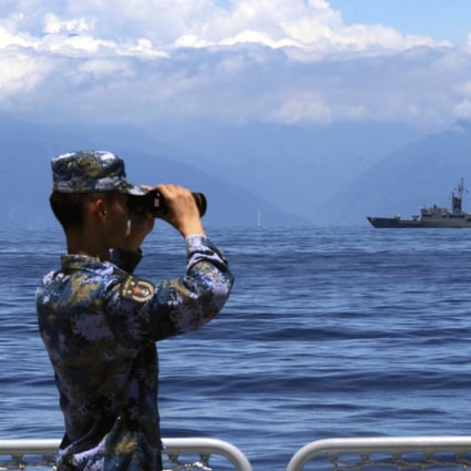 A soldier looks through binoculars during PLA Navy combat exercises and training in the waters around Taiwan on Friday. Photo: Xinhua
