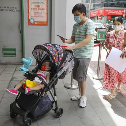 A father in Hong Kong brings his toddler for vaccination at Kwun Chung Municipal Services Building. Photo: Edmond So