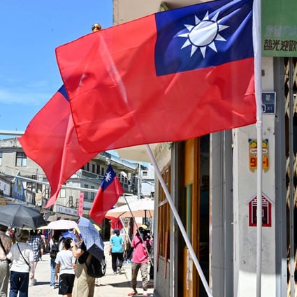 People in Kinmen island walk in a street decorated with Taiwanese flags on August 11. Photo: AFP 