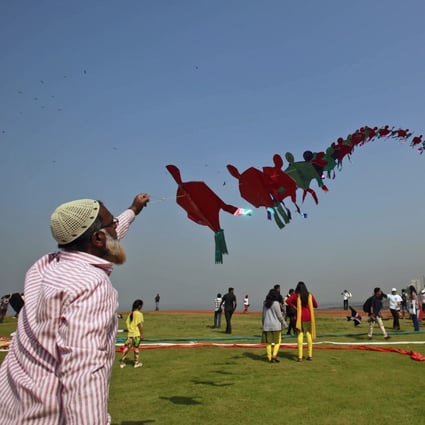 A participant flies a kite at a kite festival in India. File photo: AP