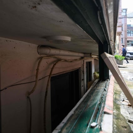 A man walks past an unscrewed security grill for a basement flat known as ‘banjiha’ where three tenants, including a disabled woman and a teenager, died after they were trapped by floodwaters in their basement home in Seoul on August 11. Photo: AFP