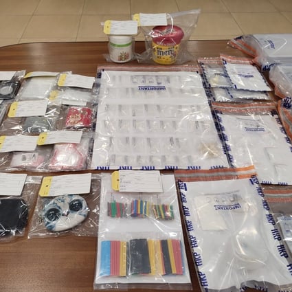 Weapons and illegal drugs  seized from a Kwai Chung public housing flat on Thursday. Photo: Handout