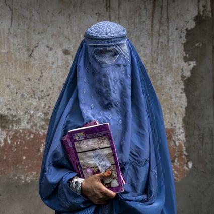 An Afghan woman leaves an underground school which she attends with her daughter, in Kabul, Afghanistan, on July 30. Photo: AP 