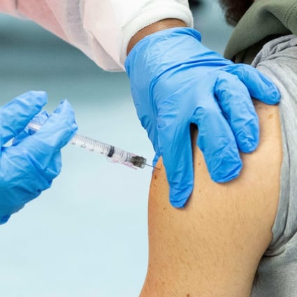 A man receives a vaccine against Covid-19. Photo: AFP