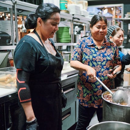 Vietnamese food vendor Nguyen Thi Thanh (middle), dubbed the “Lunch Lady” by Anthony Bourdain, in the kitchen at  Lunch Lady, a Vancouver restaurant named after her and on whose opening she collaborated. Photo: Niko Myyra