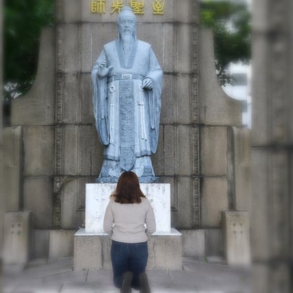 A Chinese girl kneels before a Confucius statue begging forgiveness for a low test score in a video that has gone viral in China. Photo: Handout 