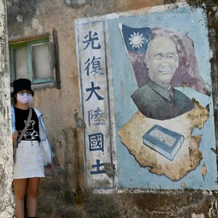 A tourist has her photo taken next to a mural of late Taiwanese president Chiang Kai-shek in Quemoy last week. Photo: AFP