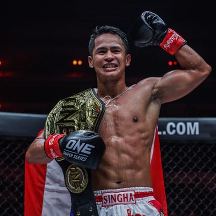 Superbon celebrates after beating Marat Grigorian to retain his featherweight kickboxing title at ONE X in Singapore.