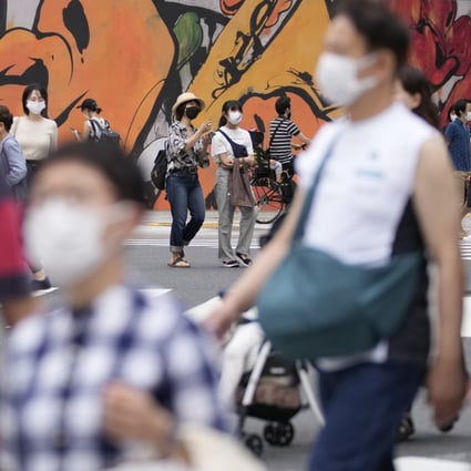 People wearing face masks walk across a pedestrian crossing in Tokyo. Women in their 20s accounted for the largest increase in suicides amid the pandemic, the Japanese study found. Photo: AP