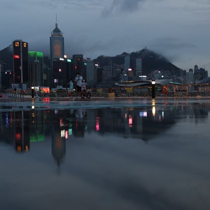 Commercial and residential buildings on Hong Kong island are reflected on the ground at East Coast Park precinct in Causeway Bay on August 5. Photo: Yik Yeung-man