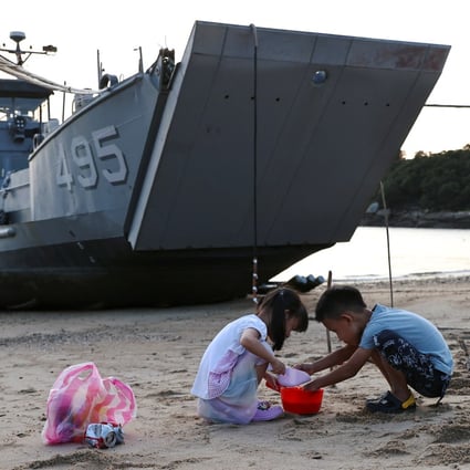 Children play near a Taiwanese navy supply ship at a beach on Nangan, in the Matsu archipelago, on Tuesday. Photo: Reuters