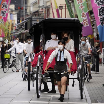 Tourists enjoy a rickshaw ride in Asakusa district in Tokyo in June. Japan’s tourism industry has welcomed news that border controls could soon be eased. Photo: EPA-EFE