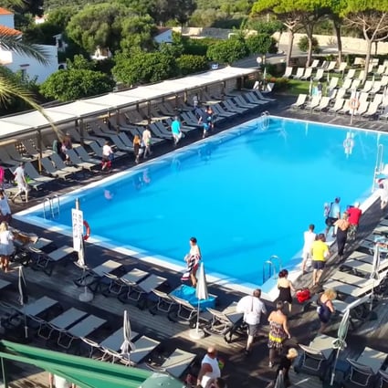 British tourists at the Hotel San Luis Menorca, on one of Spain’s Balearic islands, wait for the pool to open before scrambling to claim their spot in the sun for the day. Photo: YouTube
