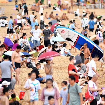 Beachgoers in Qingdao, in China’s eastern Shandong province. Falling birth levels and an ageing population have grave implications for national development. Photo: AFP