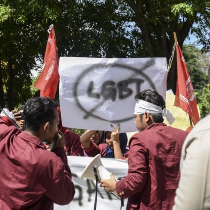 A group of Muslim protesters march with banners against the LGBT community in Banda Aceh, Indonesia in 2017. Photo: AFP