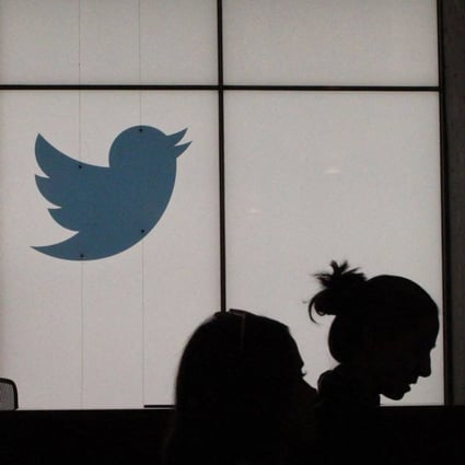 Employees walk past a lighted Twitter logo as they leave the company’s headquarters in San Francisco in August 2019. Photo: AFP