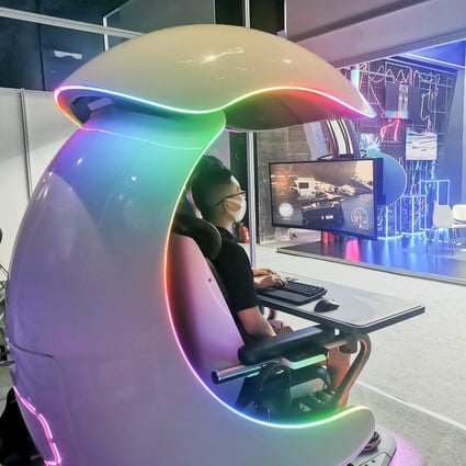 A visitor at the World Metaverse Conference in Beijing plays a racing game in a Cooler Master gaming cabin on August 26, 2022. Photo: Coco Feng