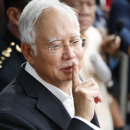 Najib Razak gestures as he leaves the Malaysian Anti-Corruption Commission Office in 2018. Photo: AP