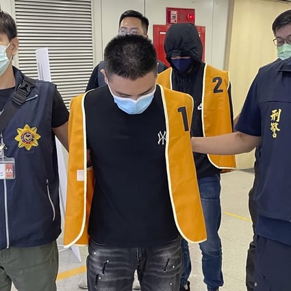Taiwanese police escort two suspects who were deported from Bangkok earlier this month and are believed to be involved in scam cases in Cambodia. Photo: Taiwan Criminal Investigation Bureau via AP