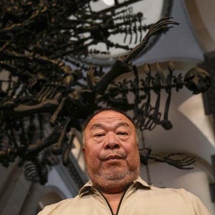 Chinese artist Ai Weiwei poses in front of his glass sculpture La Commedia Umana at the San Giorgio deconsecrated church in Venice, Italy on Friday. Photo: AP 