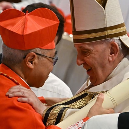 Pope Francis speaks to Monsignor William Seng Chye Goh, left, after he elevated him to Cardinal during a consistory to create 20 new cardinals, on Saturday. Photo: AFP/Getty Images