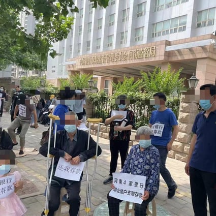 Protesters demonstrate outside the banking regulator in Zhengzhou in May in a banking crisis that continues to unfold. Photo: Weibo