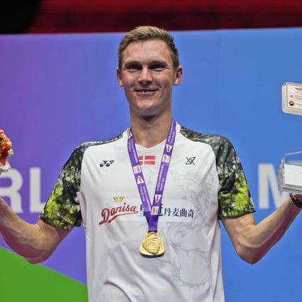 Denmark’s Viktor Axelsen celebrates on the podium with his trophy and gold medal following his victory over Thailand’s Kunlavut Vitidsarn in their men’s singles final at the BWF World Championships in Tokyo. Photo: AP