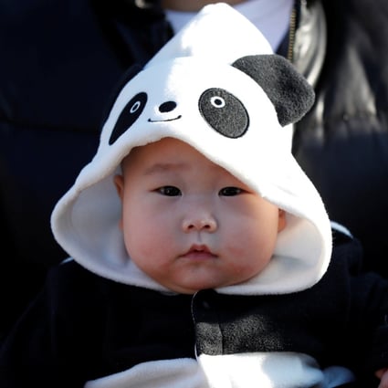 A 6-month-old baby wears a giant panda costume at a zoo in Tokyo. The nursing home in Kitakyushu has signed up more than 30 babies so far. Photo: Reuters