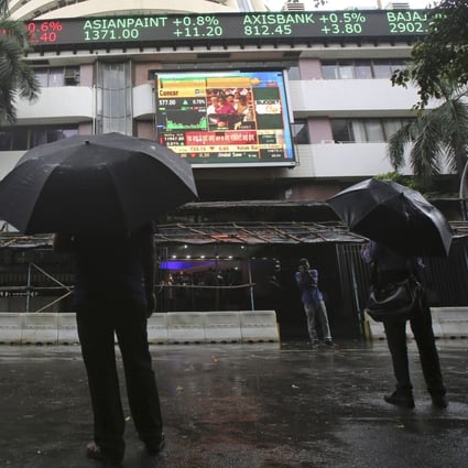 People check market prices on a display screen outside the Bombay Stock Exchange building in Mumbai, in July 2019. Photo: AP
